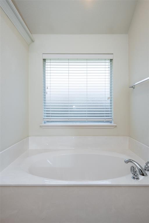 10913 Golfview Way Benbrook, TX 76126 - Photo 4 of 19 a bathroom with bathtub and next to a window