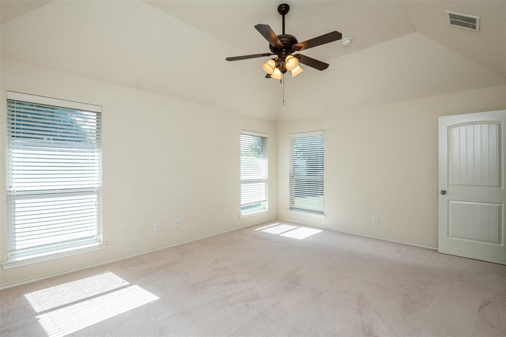 10913 Golfview Way Benbrook, TX 76126 - Photo 6 of 19 en empty room with windows and fan