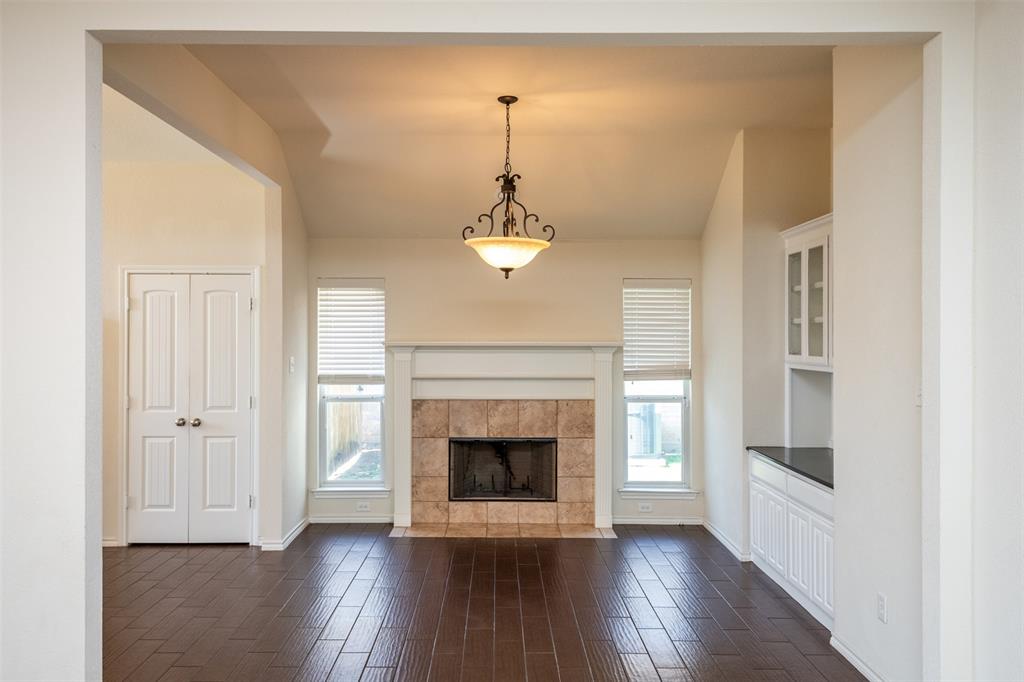 10913 Golfview Way Benbrook, TX 76126 - Photo 9 of 19 a view of a room with wooden floor fireplace and windows