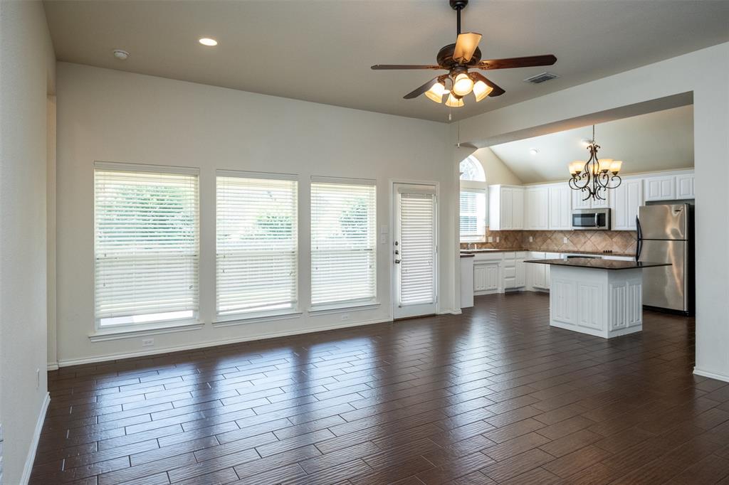 10913 Golfview Way Benbrook, TX 76126 - Photo 10 of 19 a view of a kitchen with a stove wooden floor and a chandelier