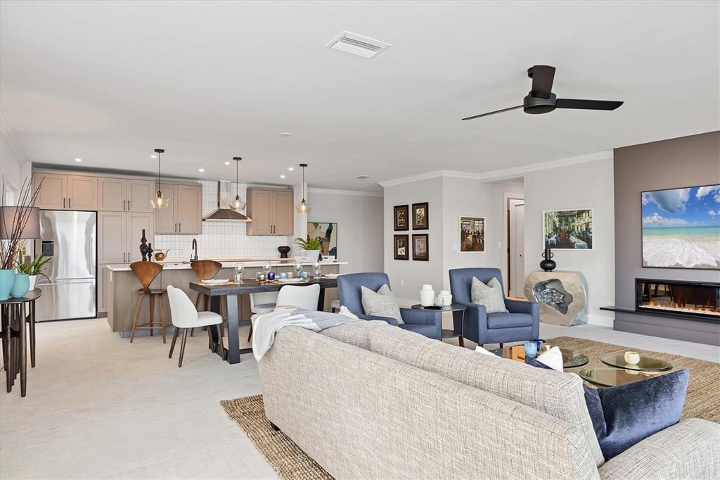 226 Golden Gate Point, Unit 12 Sarasota, FL 34236 - Photo 22 of 52 a living room with furniture and a flat screen tv