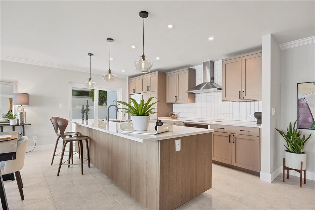 226 Golden Gate Point, Unit 12 Sarasota, FL 34236 - Photo 23 of 52 a kitchen with white cabinets and wooden floor