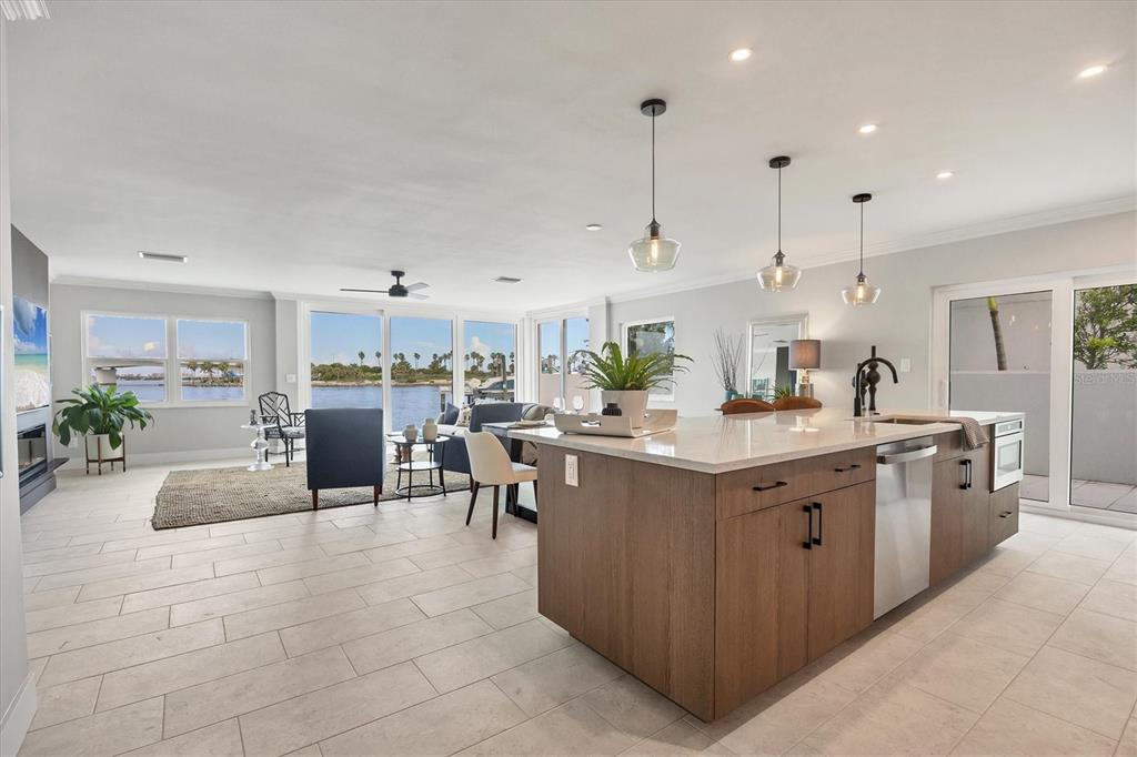 226 Golden Gate Point, Unit 12 Sarasota, FL 34236 - Photo 24 of 52 a kitchen with kitchen island granite countertop a sink counter top space appliances and cabinets