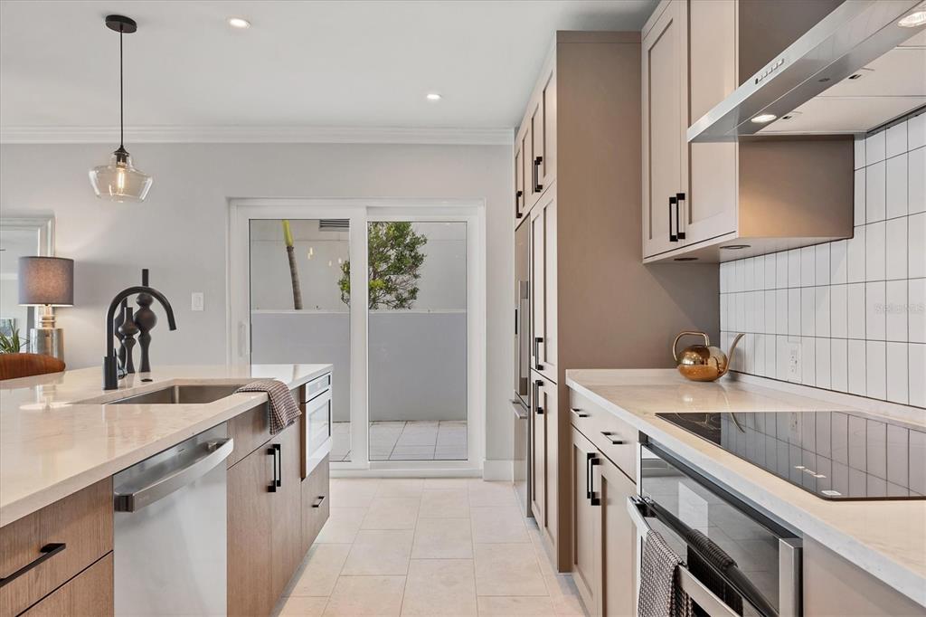 226 Golden Gate Point, Unit 12 Sarasota, FL 34236 - Photo 25 of 52 a kitchen that has a sink and a stove in it