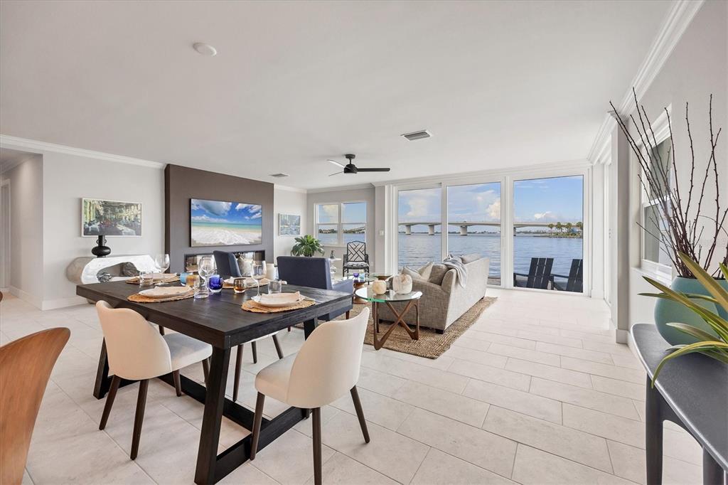 226 Golden Gate Point, Unit 12 Sarasota, FL 34236 - Photo 31 of 52 a living room with furniture a fireplace and a flat screen tv
