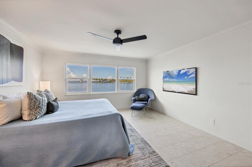 226 Golden Gate Point, Unit 12 Sarasota, FL 34236 - Photo 33 of 52 a large bedroom with a bed and window