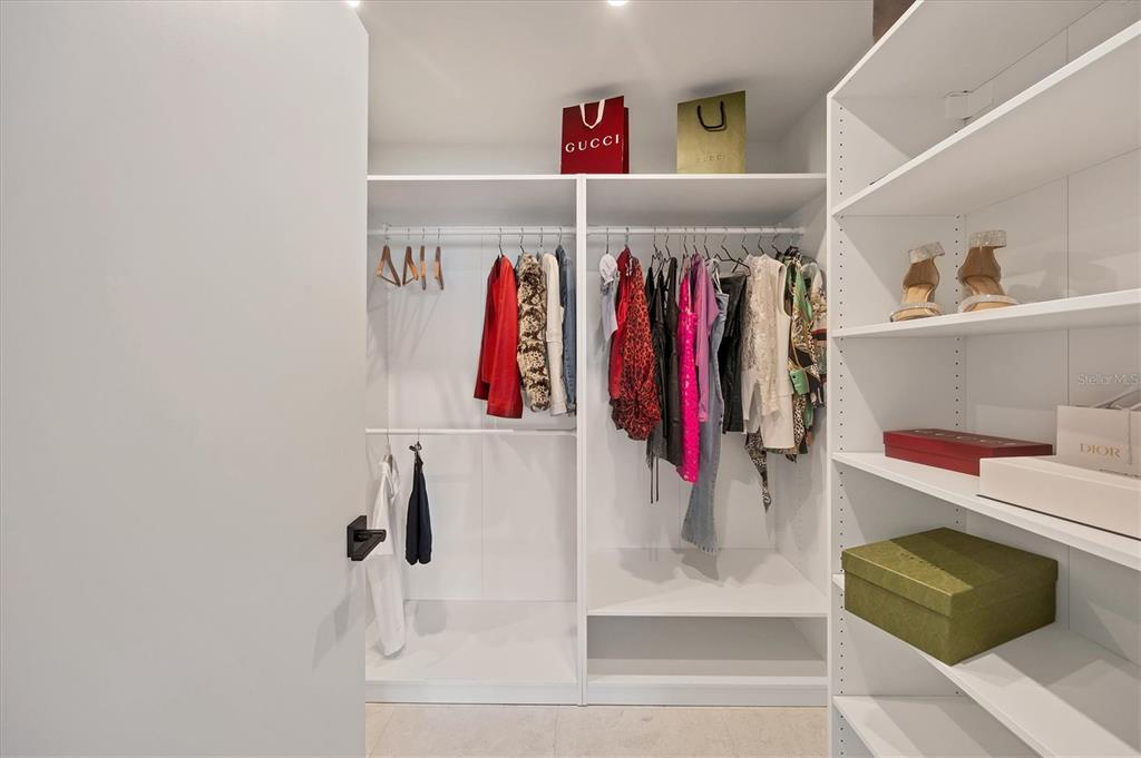 226 Golden Gate Point, Unit 12 Sarasota, FL 34236 - Photo 35 of 52 a view of walk in closet with clothes and shoes