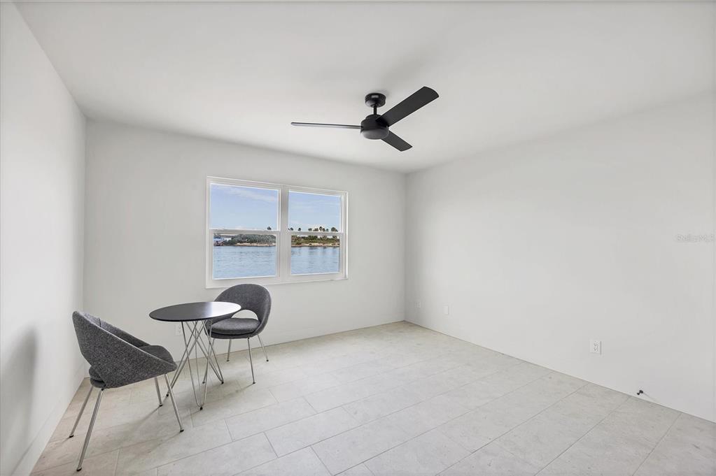 226 Golden Gate Point, Unit 12 Sarasota, FL 34236 - Photo 40 of 52 a very nice looking room with a ceiling fan and a window