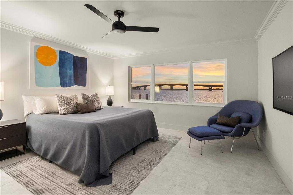 226 Golden Gate Point, Unit 12 Sarasota, FL 34236 - Photo 6 of 52 a bedroom with a bed and large windows