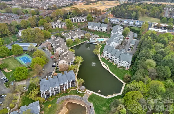 an aerial view of a house with a garden and lake view