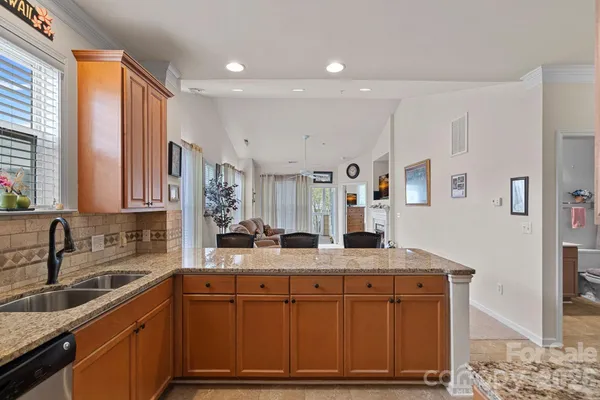 a large kitchen with a table and chairs