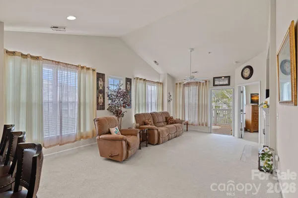 a living room with furniture a fireplace and potted plants