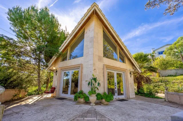 a front view of a house with garden