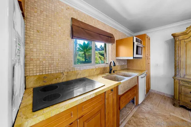 a kitchen with a sink stove and refrigerator