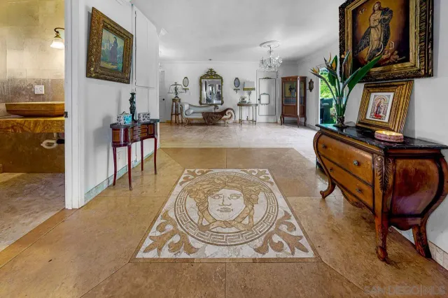 a living room with furniture a flat screen tv and kitchen view
