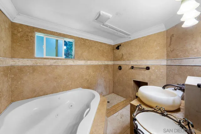 a bathroom with a sink mirror toilet and bathtub