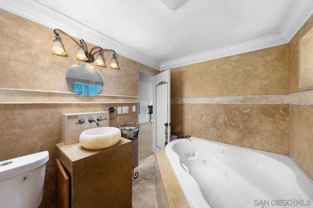 a bathroom with a tub sink and toilet