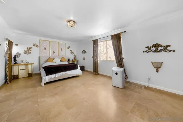 a spacious bedroom with a bed and window