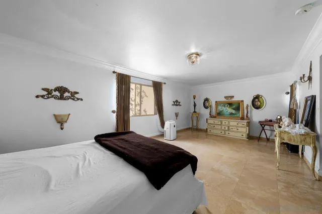 a bedroom with a large bed and a couch