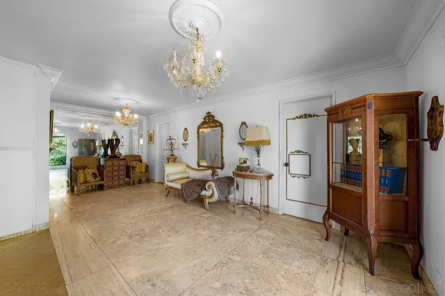 a living room with furniture chandelier and a chandelier