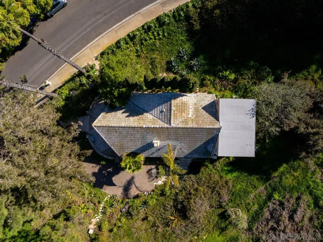 an aerial view of a house with yard and outdoor seating