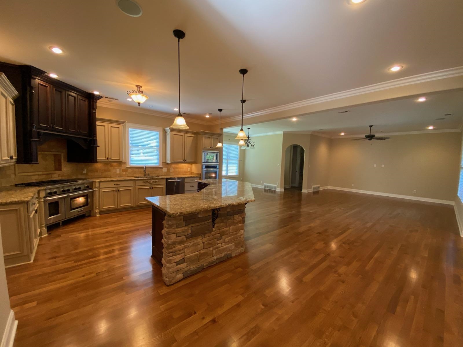930 Snowden Farm Road Collierville, TN 38017 - Photo 12 of 38 a large kitchen with kitchen island a sink stainless steel appliances and cabinets