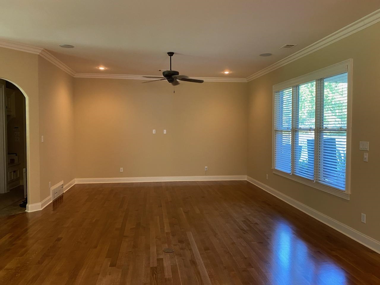 930 Snowden Farm Road Collierville, TN 38017 - Photo 17 of 38 a view of an empty room with wooden floor and a window