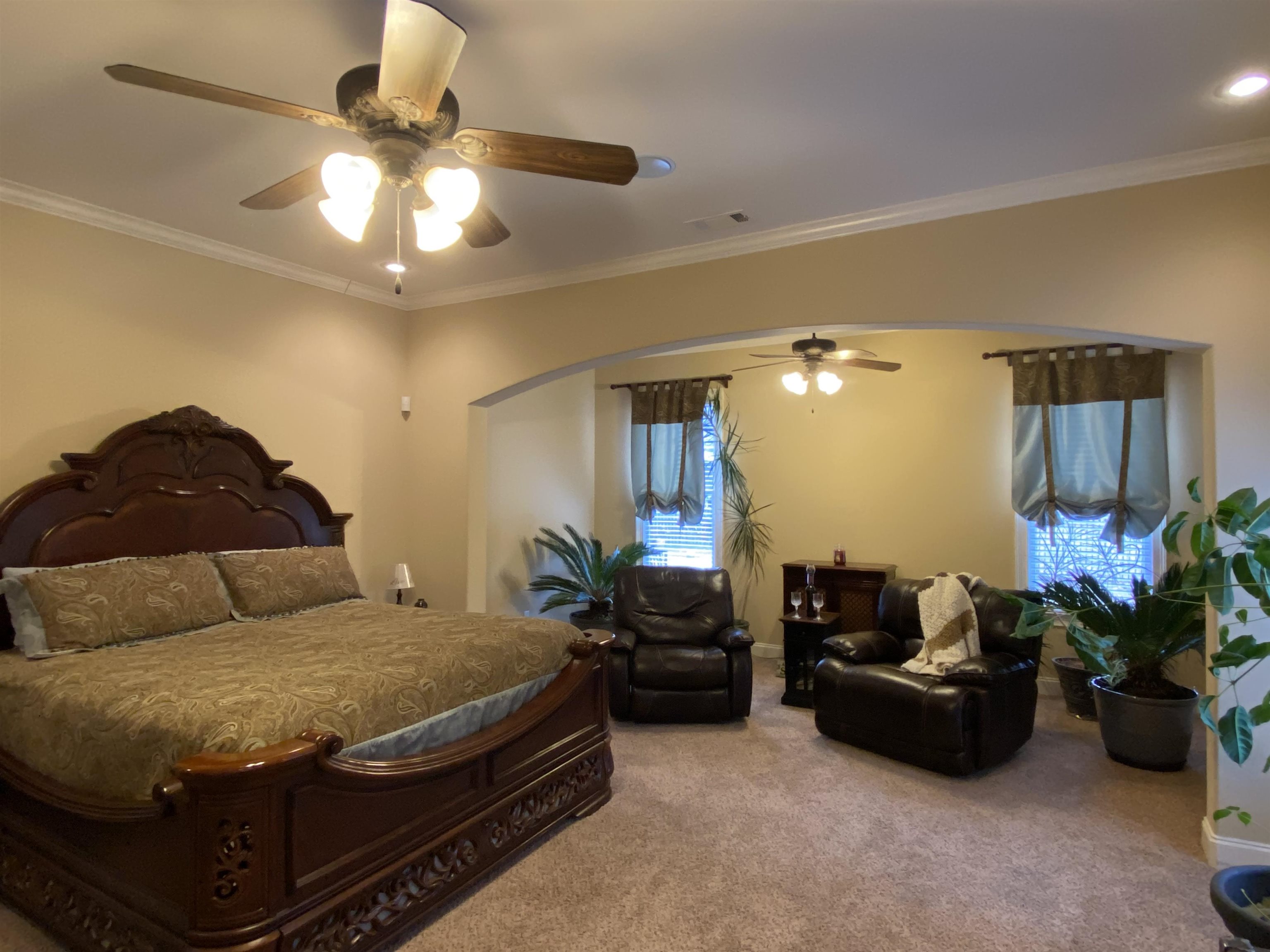 930 Snowden Farm Road Collierville, TN 38017 - Photo 21 of 38 a bedroom with a bed potted plant and a chandelier