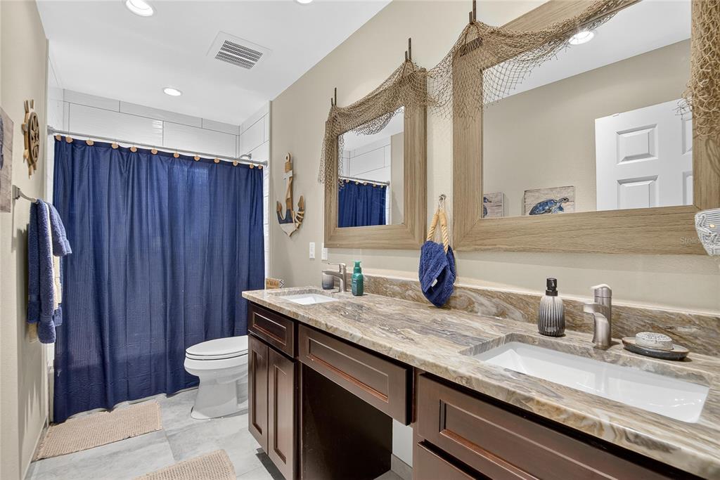 3309 Timberlee Road Wimauma, FL 33598 - Photo 14 of 55 a bathroom with a granite countertop sink and a mirror