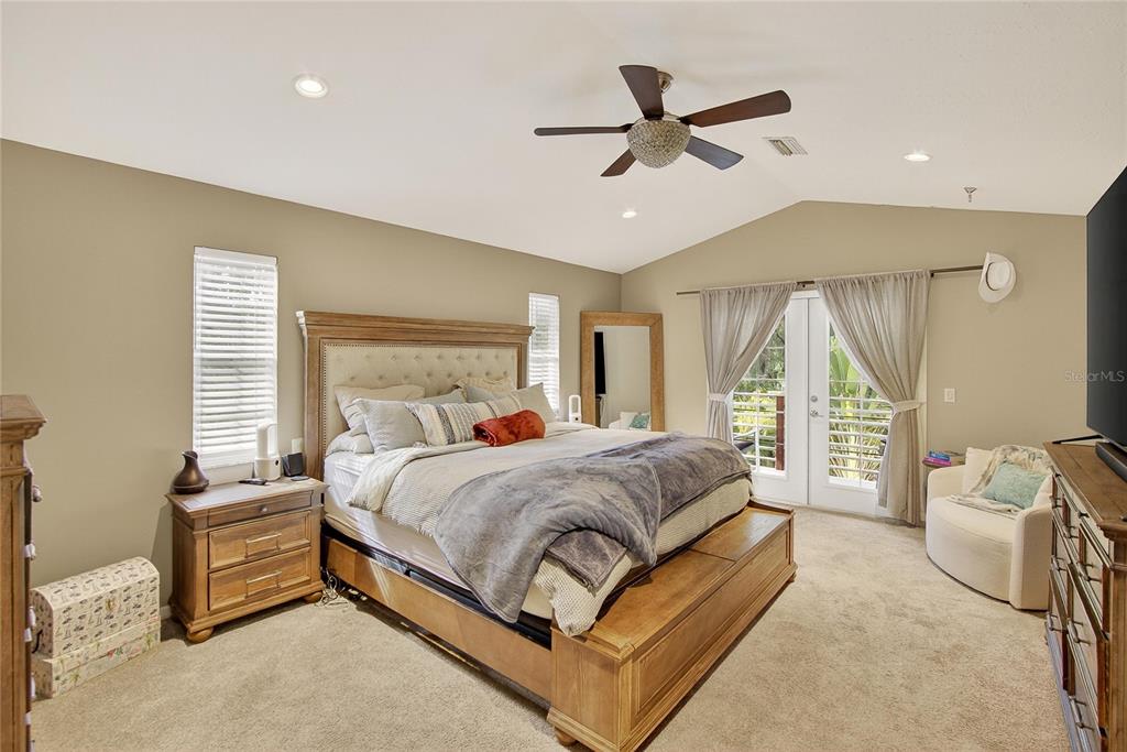 3309 Timberlee Road Wimauma, FL 33598 - Photo 17 of 55 a spacious bedroom with a bed and a ceiling fan