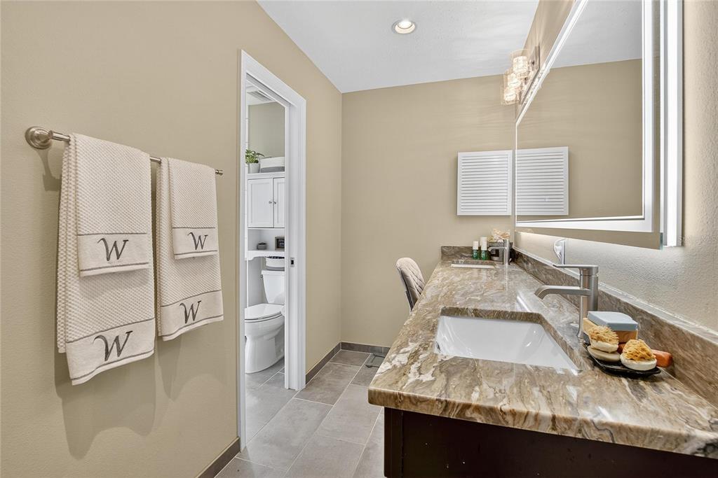 3309 Timberlee Road Wimauma, FL 33598 - Photo 19 of 55 a bathroom with a granite countertop sink and a mirror