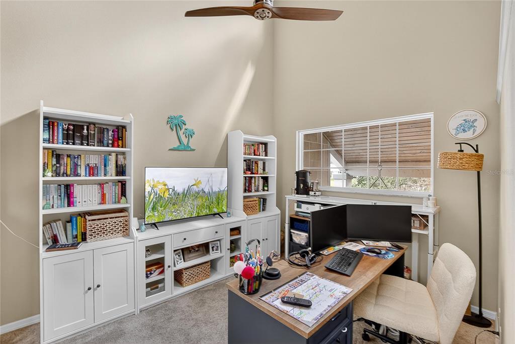3309 Timberlee Road Wimauma, FL 33598 - Photo 23 of 55 a room with furniture a rug and a book shelf