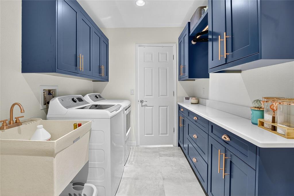 3309 Timberlee Road Wimauma, FL 33598 - Photo 25 of 55 a utility room with cabinets washer and dryer