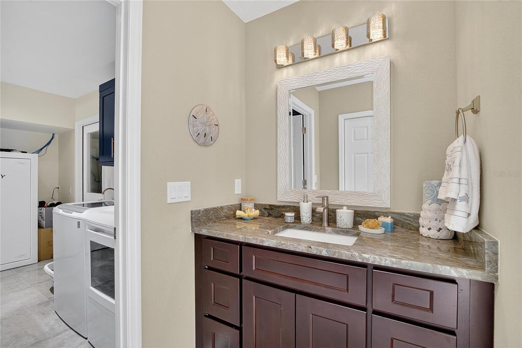 3309 Timberlee Road Wimauma, FL 33598 - Photo 27 of 55 a bathroom with a granite countertop sink and a mirror