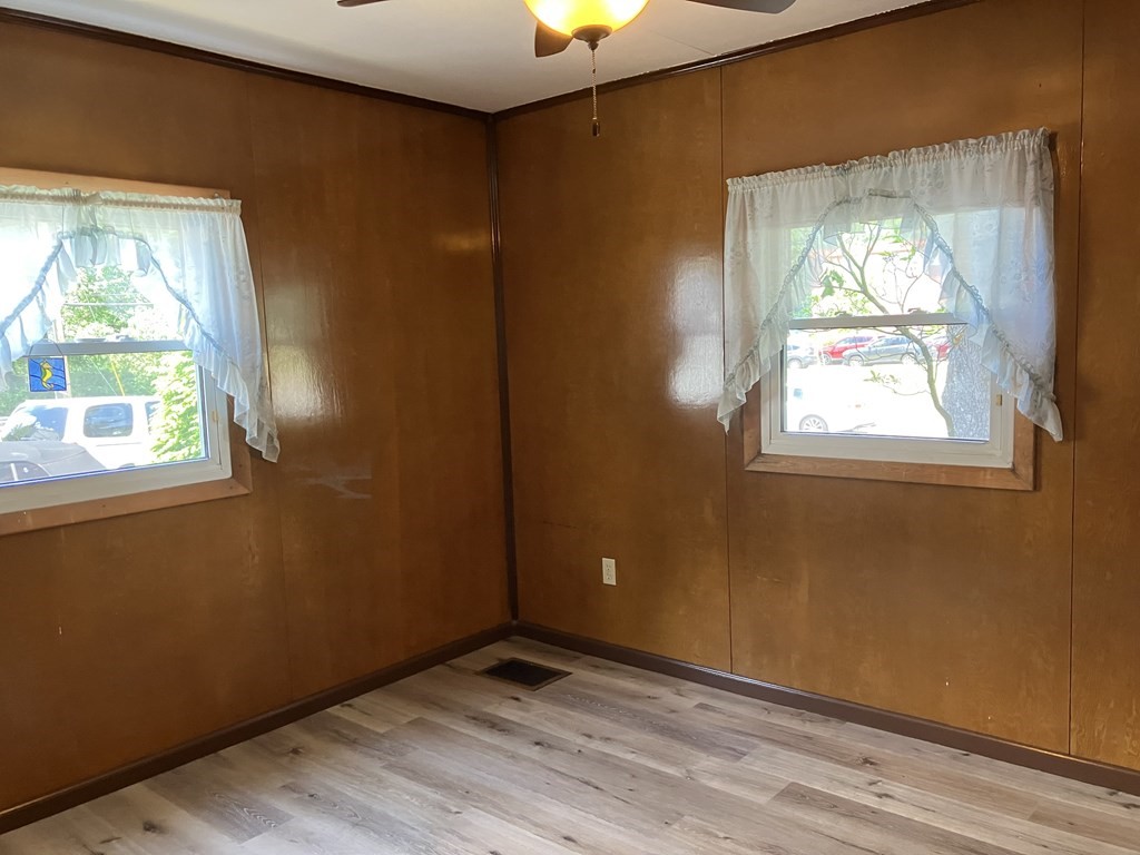 280 Tiffany Street Springfield, MA 01108 - Photo 12 of 17 a view of an empty room with wooden floor and a window
