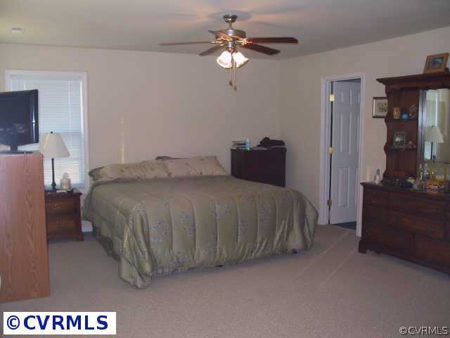 9513 Dunroming Road Chesterfield, VA 23832 - Photo 6 of 6 a bedroom with a bed chandelier dresser and a chandelier