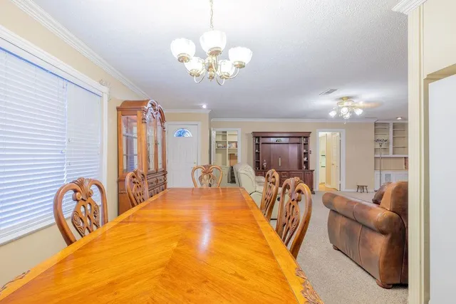 a view of a livingroom with furniture and chandelier