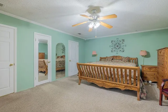a bedroom with furniture and a chandelier