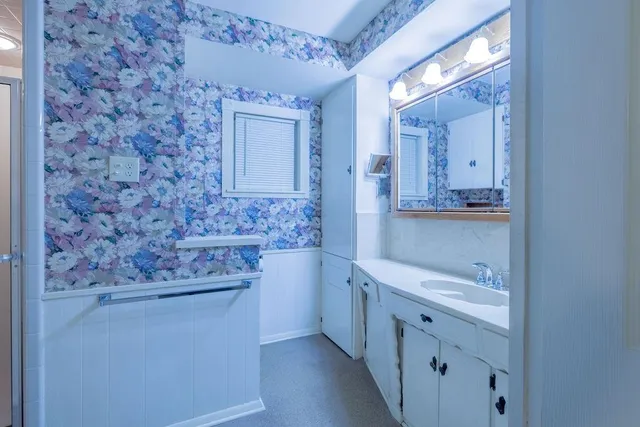 a bathroom with a sink a toilet and mirror