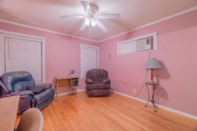 a living room with furniture and a ceiling fan