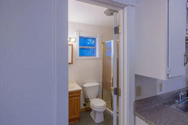 a white toilet sitting next to a bathroom sink