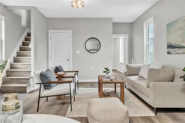 a living room with furniture and wooden floor