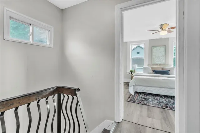 a view of a hallway with furniture and staircase