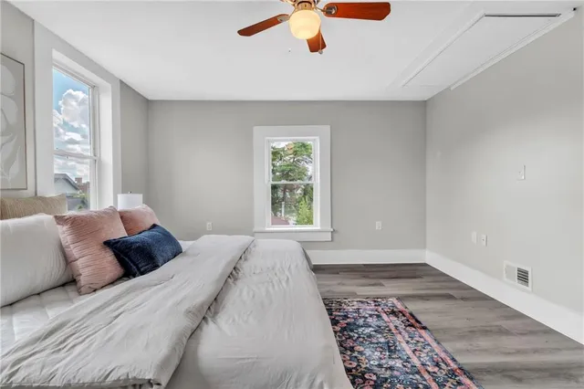 a bedroom with a large bed and a window