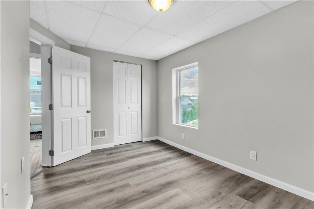 305 1/2 East Lutton Street New Castle, PA 16101 - Photo 24 of 39 wooden floor in an empty room with a window