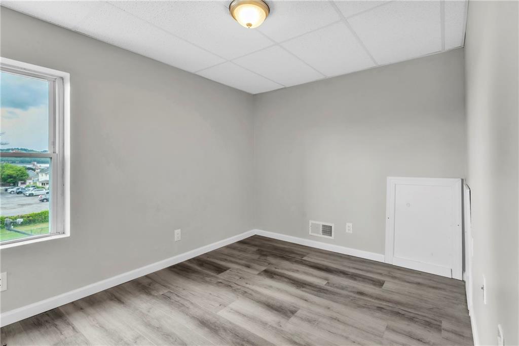 305 1/2 East Lutton Street New Castle, PA 16101 - Photo 25 of 39 a view of empty room with wooden floor and window