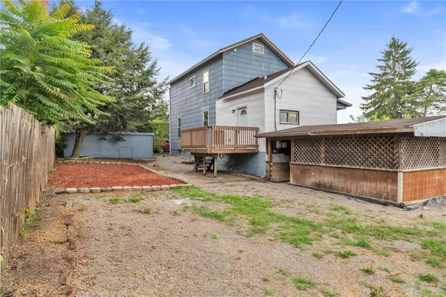 a view of balcony with wooden floor and fence