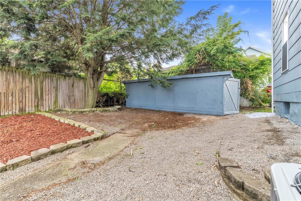 305 1/2 East Lutton Street New Castle, PA 16101 - Photo 32 of 39 a front view of a house with a yard and garage