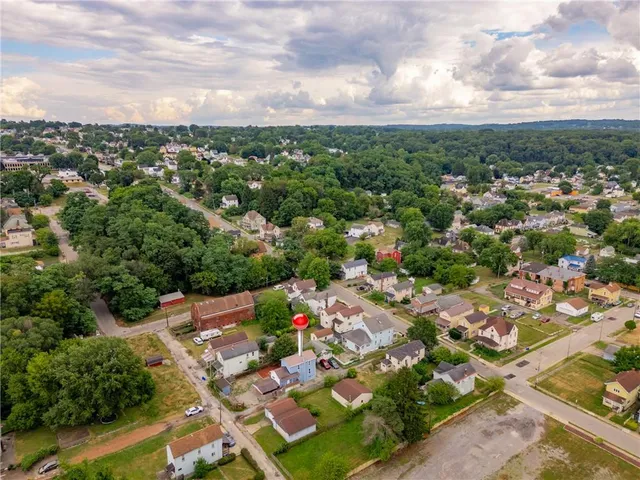 an aerial view of residential houses with city view