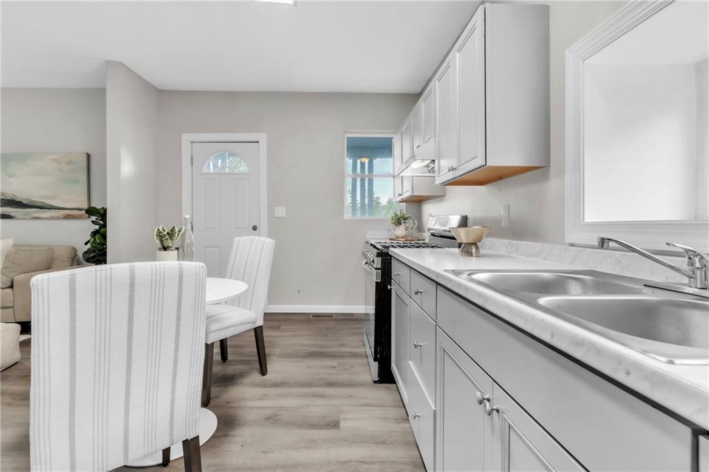 305 1/2 East Lutton Street New Castle, PA 16101 - Photo 5 of 39 a kitchen with a sink cabinets and wooden floor